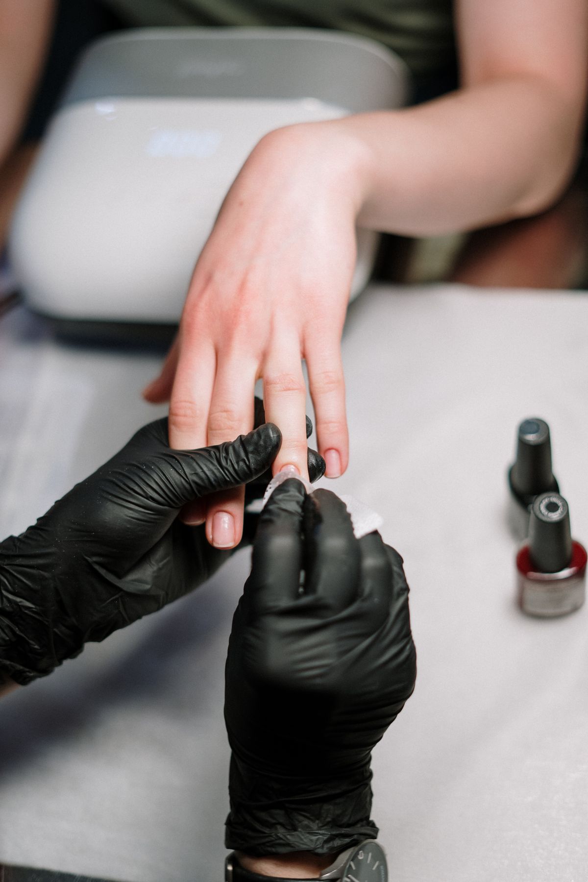 Technician applying acrylic-free gel manicure at Noir Haus Nails